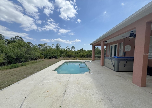 pool with a patio, a ceiling fan, and a hot tub