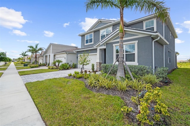 traditional-style house with stucco siding, driveway, an attached garage, and a front yard