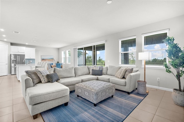 living room featuring light tile patterned floors, visible vents, recessed lighting, and baseboards