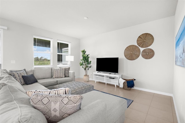 living room featuring tile patterned floors and baseboards