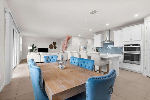 dining room featuring baseboards, visible vents, light tile patterned flooring, and recessed lighting