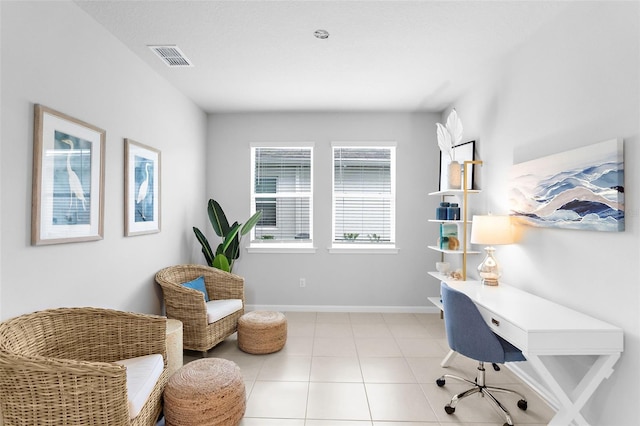 office space with tile patterned floors, visible vents, and baseboards