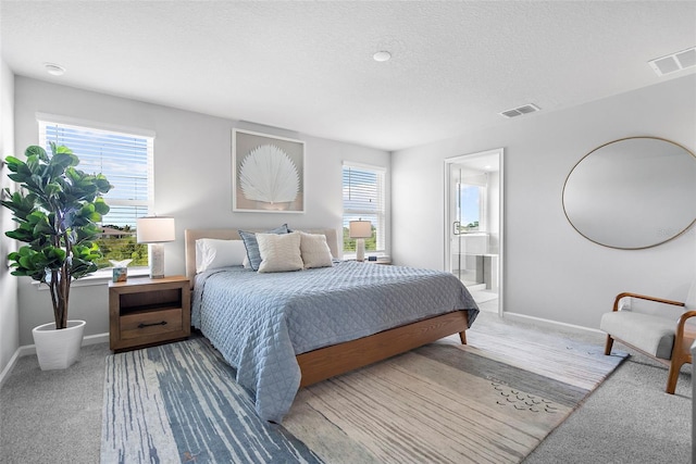 carpeted bedroom featuring baseboards, visible vents, a textured ceiling, and connected bathroom