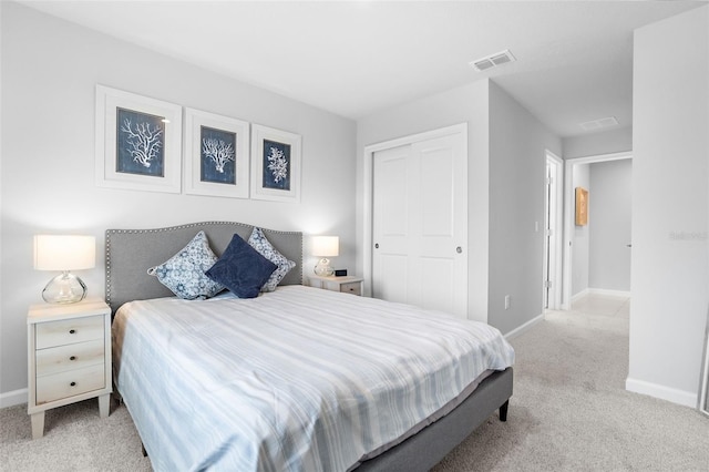 carpeted bedroom with baseboards, visible vents, and a closet