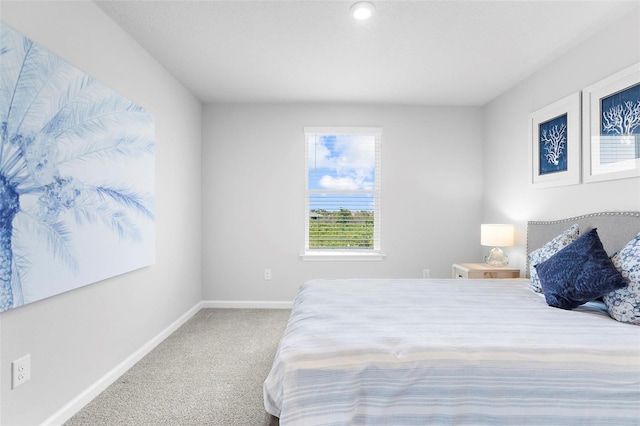carpeted bedroom with baseboards