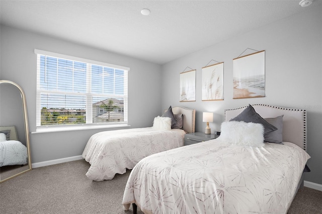 bedroom with carpet and baseboards