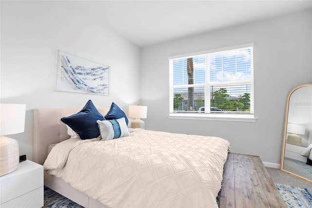 carpeted bedroom featuring baseboards