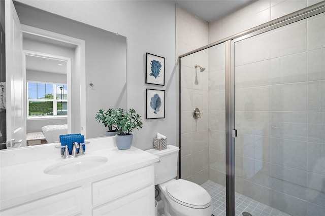 ensuite bathroom featuring vanity, connected bathroom, and a shower stall