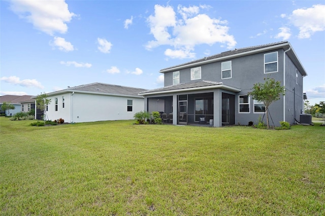 back of house with cooling unit, a sunroom, a yard, and stucco siding