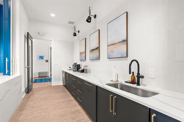 interior space with visible vents, recessed lighting, light wood finished floors, and a sink