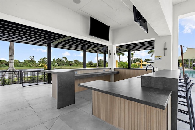 view of patio featuring outdoor wet bar and a sink