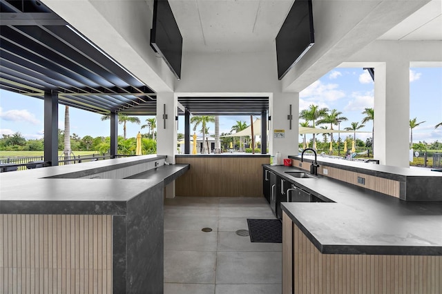 view of patio / terrace featuring outdoor wet bar and a sink