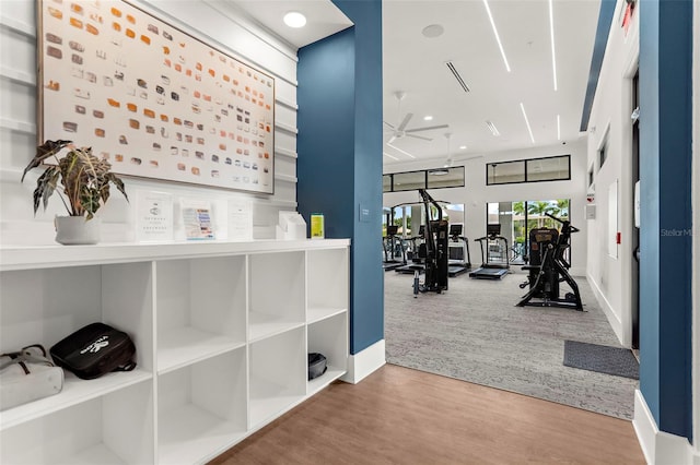 interior space featuring wood finished floors, a ceiling fan, recessed lighting, and baseboards