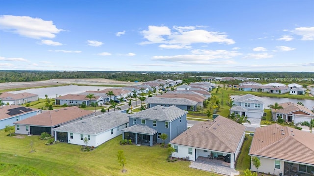 drone / aerial view featuring a residential view and a water view