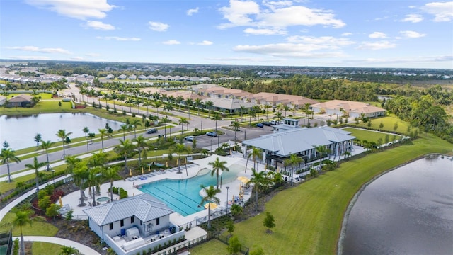 drone / aerial view featuring a residential view and a water view