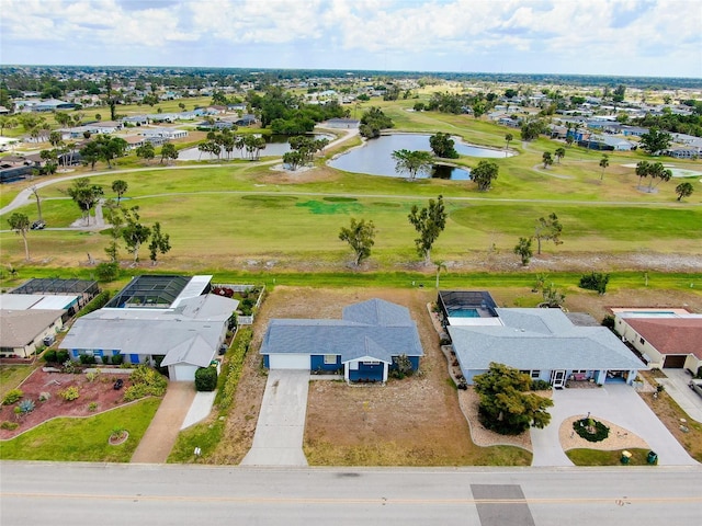 drone / aerial view with a residential view, a water view, and golf course view