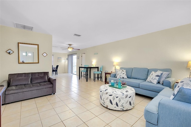 living area featuring ceiling fan, light tile patterned flooring, and visible vents
