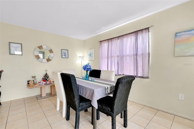dining area featuring baseboards and light tile patterned floors