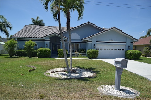 ranch-style home with concrete driveway, a tiled roof, a front lawn, and a garage