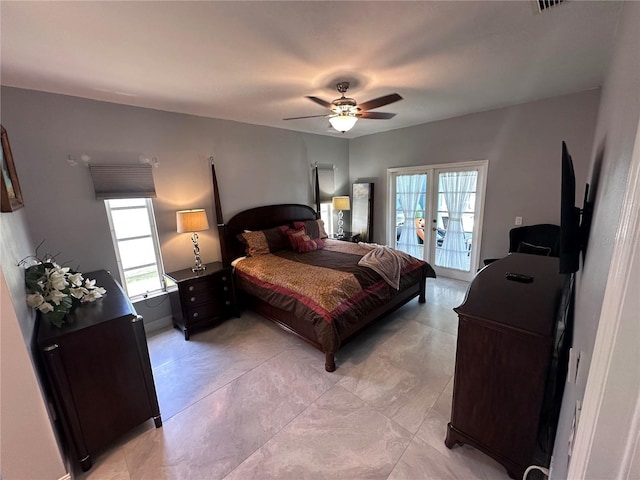 bedroom featuring french doors, access to exterior, a ceiling fan, and multiple windows