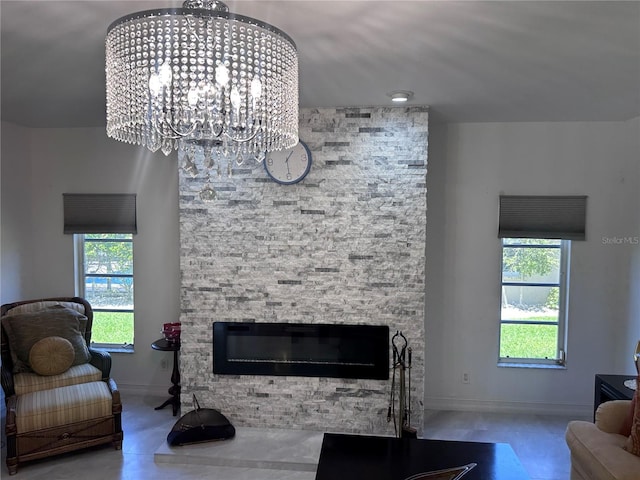 living area with baseboards, a wealth of natural light, and a fireplace