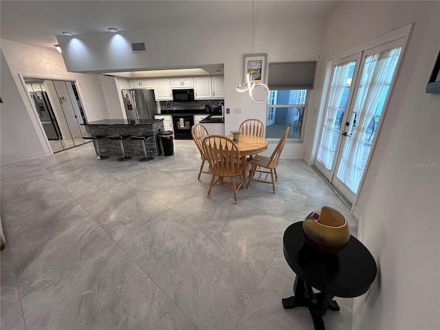 dining room with visible vents, french doors, and baseboards