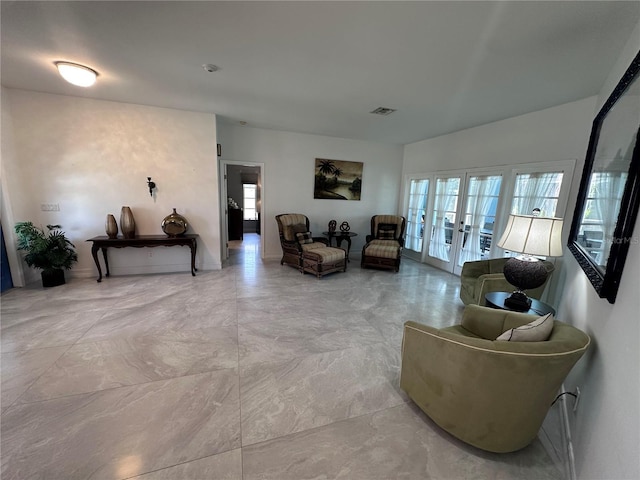 living room featuring visible vents, a wealth of natural light, and french doors