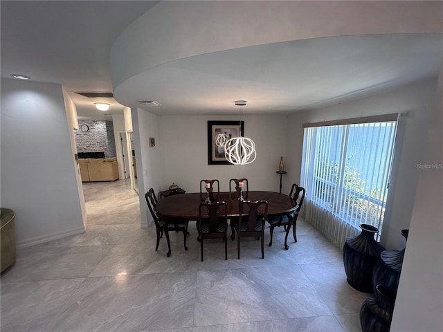 dining area featuring visible vents and an inviting chandelier