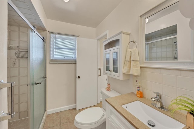 bathroom with tile patterned flooring, vanity, toilet, backsplash, and a stall shower