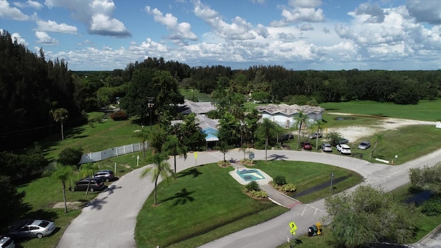 birds eye view of property featuring a forest view