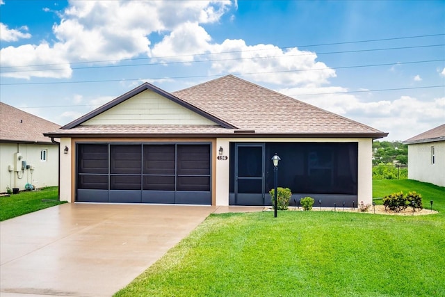 ranch-style home with roof with shingles, stucco siding, a garage, and a front yard