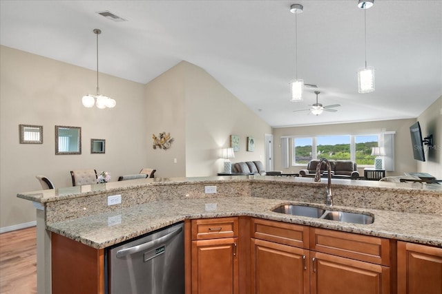 kitchen featuring visible vents, stainless steel dishwasher, vaulted ceiling, a sink, and open floor plan