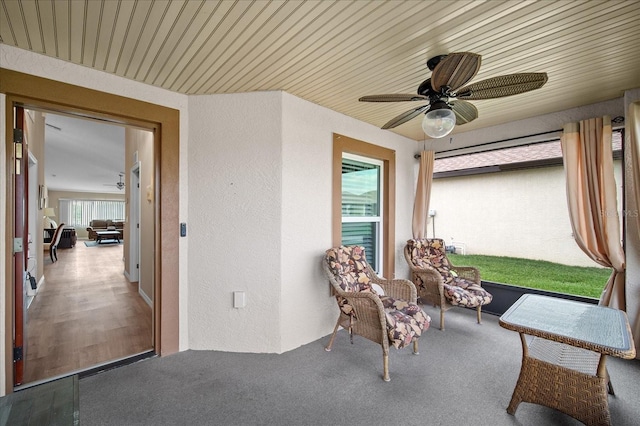 sunroom / solarium featuring a ceiling fan