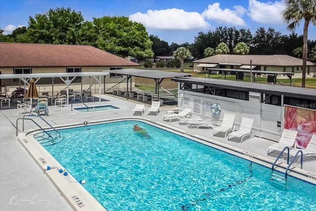 community pool featuring a patio and a community hot tub