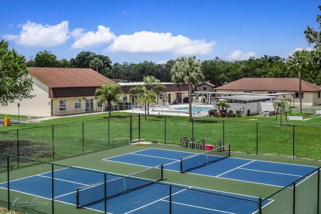 view of sport court with a yard, community basketball court, and fence