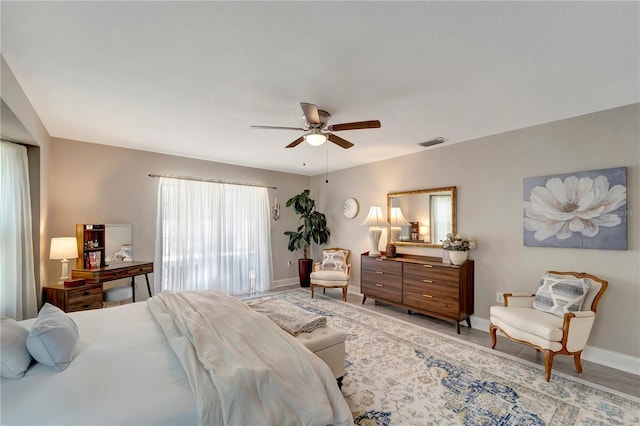 bedroom with visible vents, ceiling fan, and baseboards