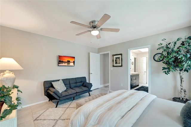 bedroom featuring tile patterned floors, ceiling fan, ensuite bath, and baseboards