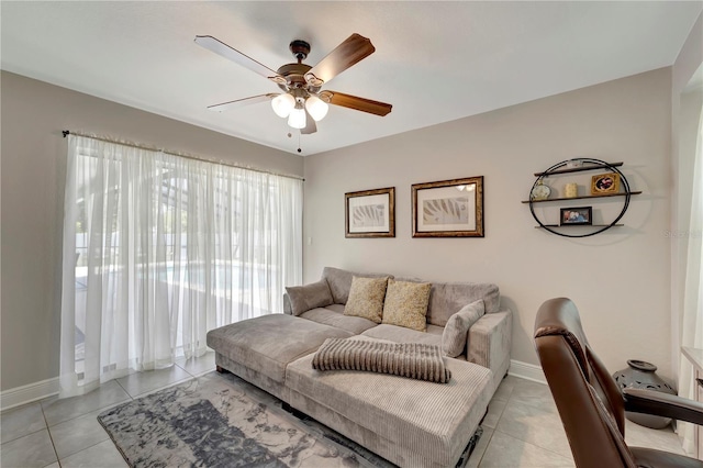 living room featuring light tile patterned flooring, a ceiling fan, and baseboards