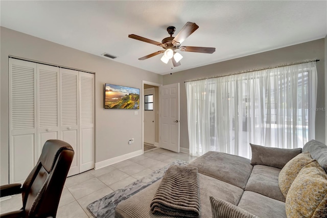 office area featuring light tile patterned floors, visible vents, plenty of natural light, and a ceiling fan