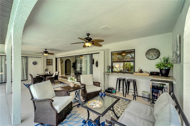 view of patio / terrace featuring outdoor lounge area, a ceiling fan, and exterior bar