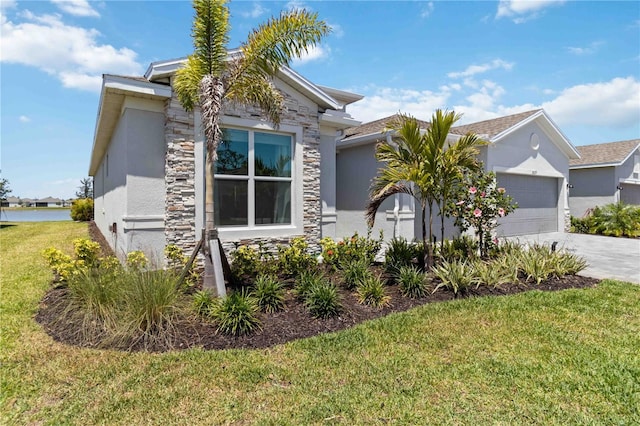 view of front of property with an attached garage, stone siding, stucco siding, a front yard, and concrete driveway