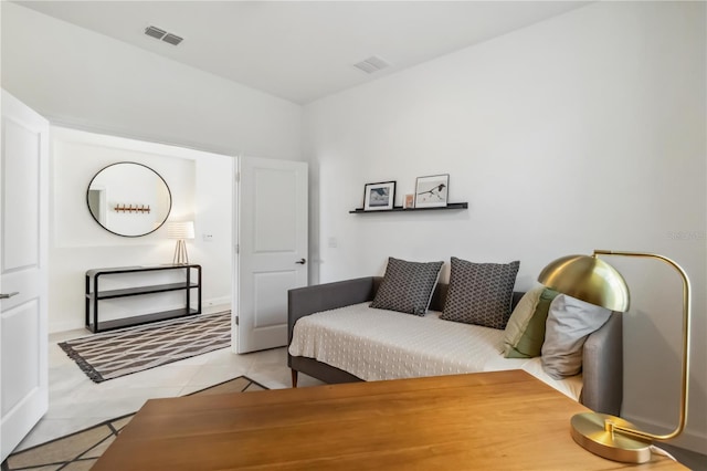 bedroom featuring light tile patterned floors and visible vents