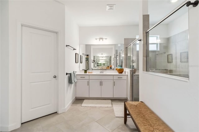 bathroom featuring vanity, tile patterned flooring, and a shower stall