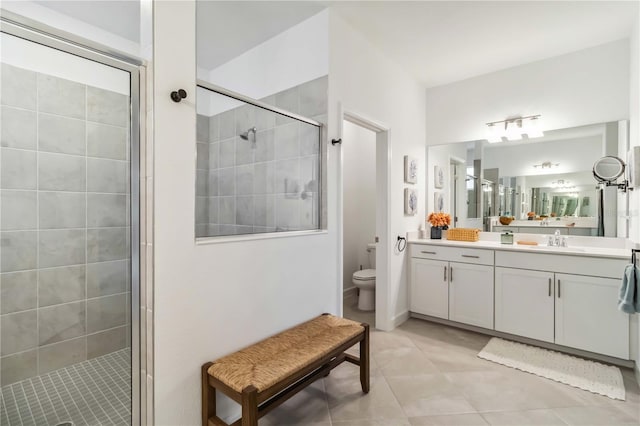 full bath featuring toilet, tile patterned floors, a shower stall, and vanity
