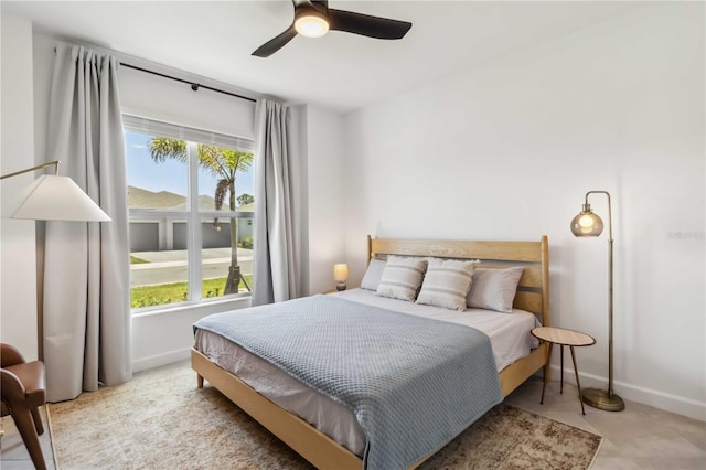 bedroom with baseboards, multiple windows, and ceiling fan