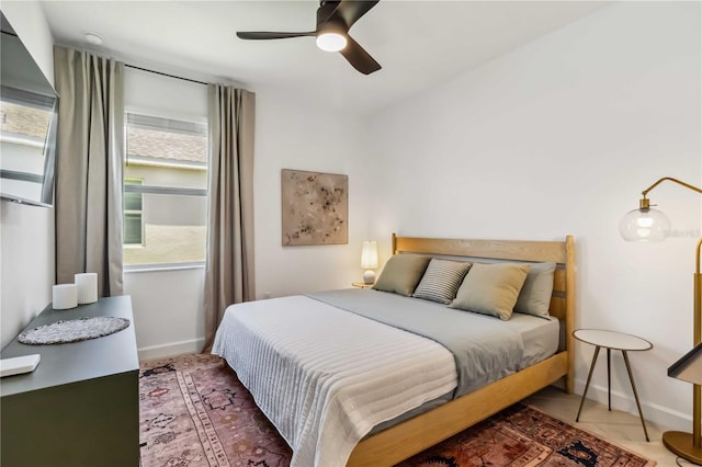 bedroom featuring baseboards and ceiling fan