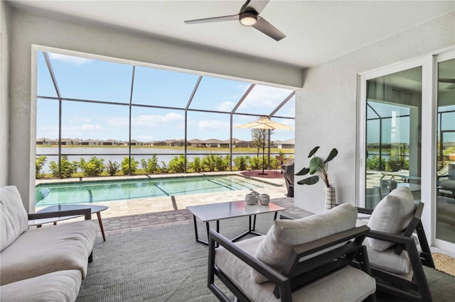 pool with a water view, an outdoor living space, a ceiling fan, a patio, and glass enclosure