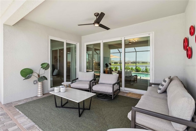 exterior space featuring a water view, ceiling fan, and a sunroom