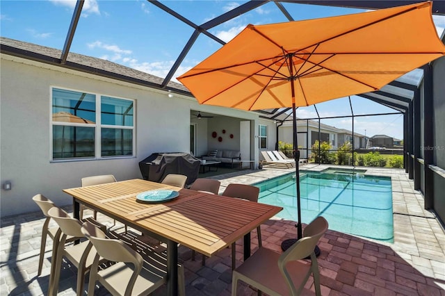 pool featuring a ceiling fan, outdoor lounge area, a lanai, and a patio area