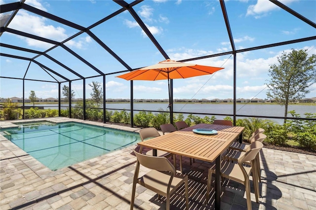 outdoor pool with a patio, a water view, a lanai, and outdoor dining area